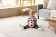 © Pixel-Shot - Cute little boy with soccer ball at home