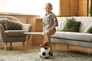 Wall Mural - Happy boy with soccer ball playing in room