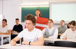 © JackF - Students study in classroom, teacher stands behind with flag of Denmark
