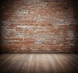 © Aaron - An old brick wall with a wooden floor, creating a rustic and vintage backdrop