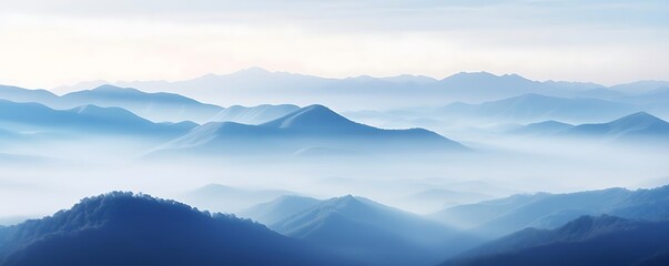 Wall Mural - misty mountain range under a white and blue sky