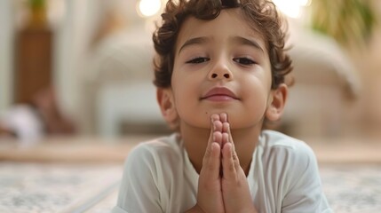 A young boy is praying on the floor, prayer concept