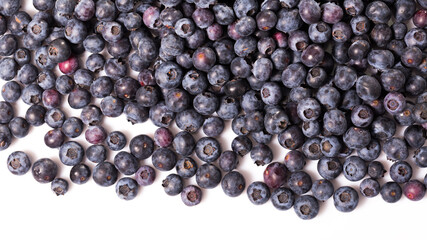 Wall Mural - Healthy vitamin food. Ripe berries of fresh sweet bilberries on white background..