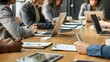 © hisilly - Business Meeting: A Group of People Focused on a Laptop Screen at the Conference Table