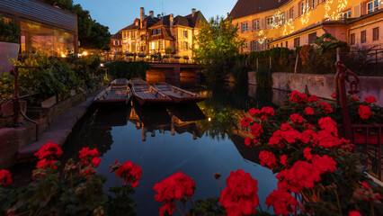 Wall Mural - A colored night and reflection in Petite Venise of Colmar in France on 15th march 2024