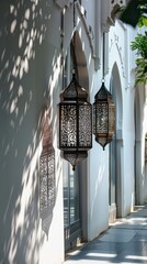 Sticker - Elegant Islamic lanterns casting intricate shadows against a white wall, creating a captivating display.