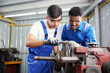 © offsuperphoto - workers or technicians working and checking lathe machine in the factory