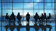 © Piyapat - Silhouettes of business people meeting in a modern office room with large windows, discussing and strategizing corporate matters.