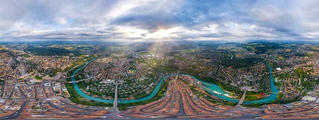 Wall Mural - Bern, Switzerland. Panorama of the city in cloudy weather. Sun rays. Summer morning. Panorama 360. Aerial view