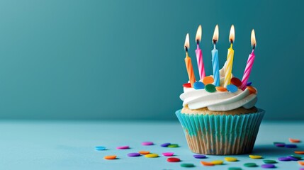 Colorful birthday candles on cupcake blue background