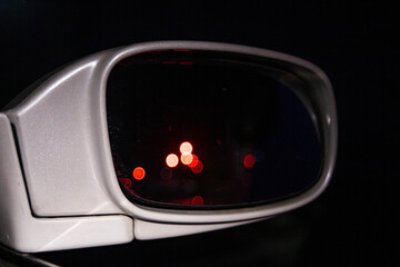 Wall Mural - traffic lights and road lights reflected in a dirty rear-view mirror of a car, making dangerous driving on the highway difficult