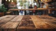 © Yin - a close up of a rustic empty wooden table with blurred coffee shop background