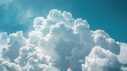 Wall Mural - Fluffy clouds against a blue sky with space for copy