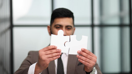 businessman show white jigsaw in hand, business strategy concept