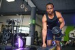 © Serhii - healthy african man working out with dumbbells in gym