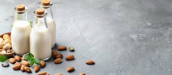 Aufkleber - Vegan alternative nut milk in glass bottles on a gray background. Healthy vegan food concept. Copy space image. Place for adding text or design