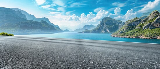 Wall Mural - Asphalt road and mountain with blue sea natural landscape. Copy space image. Place for adding text or design