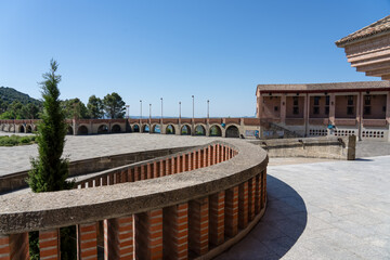 large red brick spanish building under blue sky, the Santuario de Torreciudad, a spectacular Marian shrine in honor of the Blessed Virgin Mary