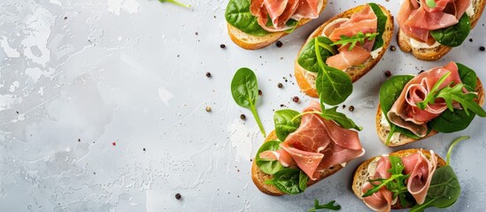 Aufkleber - Tasty ham, jamon bruschettas with lettuce and spinach on pastel background. with copy space image. Place for adding text or design