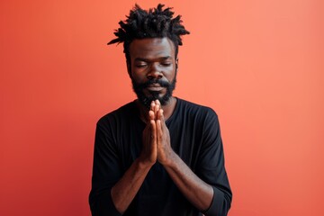 Sticker - Portrait of a tender afro-american man in his 30s joining palms in a gesture of gratitude in front of solid color backdrop