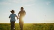 © maxximmm - boy girl a running in the park. happy family kid dream holiday concept. children hold hands brother sister run across the field silhouette summer in the park sun. kids run
