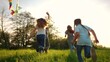 © maxximmm - happy family. big family running with a kite. people in the park children child running together in the park at sunset silhouette. mom fun dad daughter and son are running. concept dream. kids run