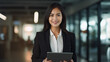 © daniil - young beautiful asian business woman looking towards the camera, business woman using her laptop for data research