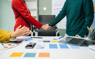 Wall Mural - close up view of ui developer team brainstorming on their project with laptop, smartphone and digita