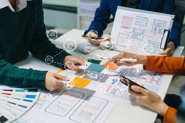 Wall Mural - close up view of ui developer team brainstorming on their project with laptop, smartphone and digita