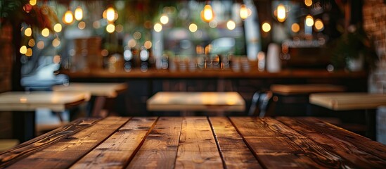 Wall Mural - Selected focus empty brown wooden table and Coffee shop or restaurant blur background with bokeh image. for your photomontage or product display. with copy space image