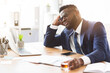 © Prostock-studio - Things getting worse. Young african american businessman drinking from stress, holding glass of whiskey, holding his head, office interior, copy space