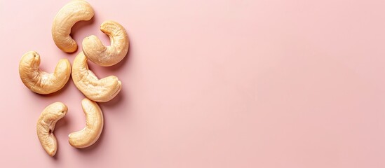 Wall Mural - Tasty organic cashew nut isolated on pastel background. with copy space image. Place for adding text or design