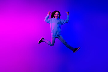 Poster - Full length photo of shiny attractive little lady dressed hoodie jumping high showing v-signs isolated neon pink color background