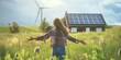 © Iryna - A girl walks through a meadow with renewable energy installations, highlighting sustainable power sources.