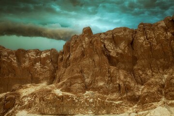 Wall Mural - Scenic view of a rocky, rugged landscape with a dramatic sky above it