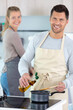 © auremar - couple cooking together in the kitchen at home