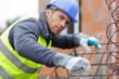© auremar - worker is fixing a steel rebar at building site