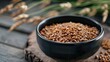 © pngking - Close up of buckwheat in a black bowl on a wooden surface