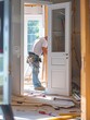 © Anat art - A construction worker meticulously installs a new interior door, showcasing the professionalism and care involved in home renovation projects. Generative AI