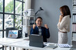© Wasana - A man and a woman are in a room with a white desk