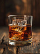 © SashaMagic - Whiskey glass with ice cubes on a wooden surface.
