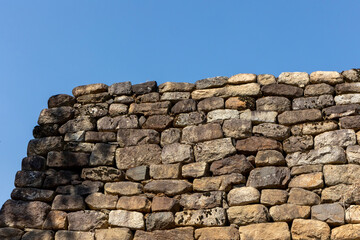 Wall Mural - stone wall with blue sky background