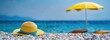 © rui - Close-up of Yellow Straw Hat with Blue Ribbon on Beach