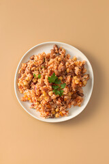 Jambalaya with rice chickpeas and kidney beans on beige table