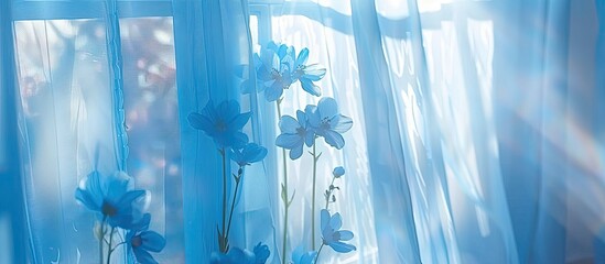 Wall Mural - background. a transparent curtain on a window of blue color with blue flowers. light through the cur