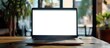© Ilgun - laptop computer showing blank screen on work table. Copy space image. Place for adding text and design