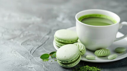 Sticker - A white cup with matcha green tea and macaroon cookies on a background of gray