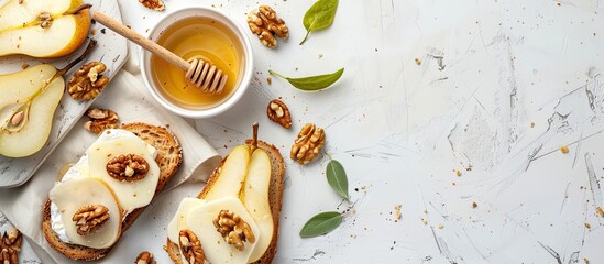 Canvas Print - Toast with cheese, pear, honey and nuts. Delicious breakfast or snack on a light background, top view. Copy space image. Place for adding text and design