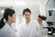 © zhu difeng - doctor using microscope in lab