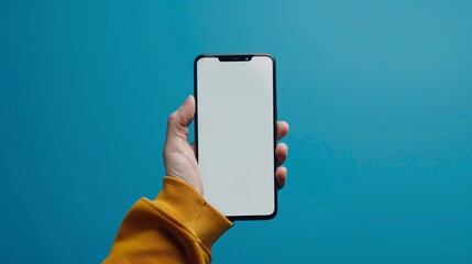 Wall Mural - A male hand holding a bezel-less smartphone with a blank screen, isolated against a blue background. The screen is cut out with a path.